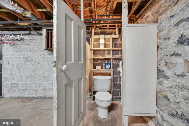 a view of water heater room with refrigerator