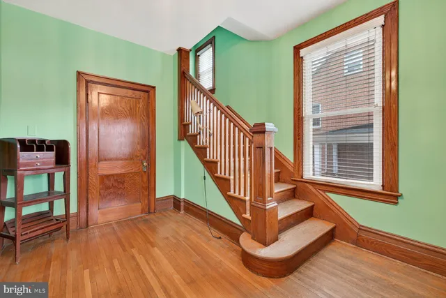 a view of entryway and hall with wooden floor