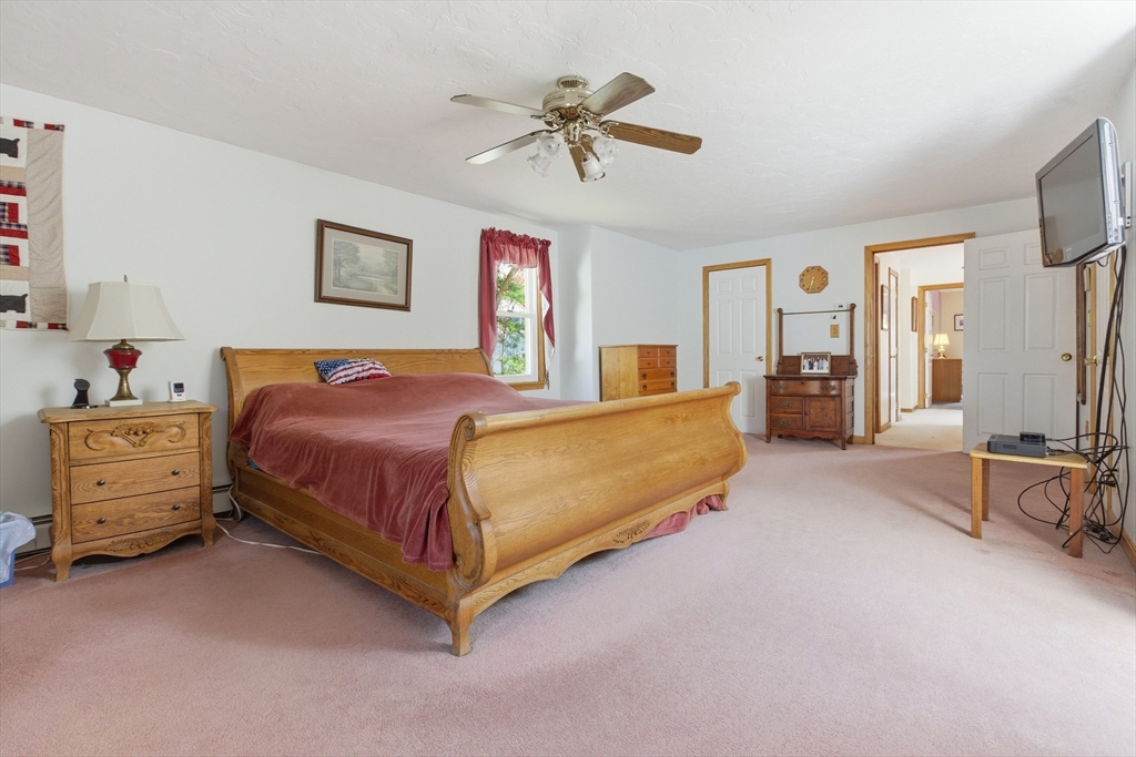 19 Mockingbird Lane Maynard, MA 01754 - Photo 22 of 34 a bedroom with a bed and a chandelier