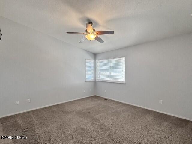 602 Tamsen Road Fernley, NV 89408 - Photo 17 of 18 an empty room with a window and a ceiling fan