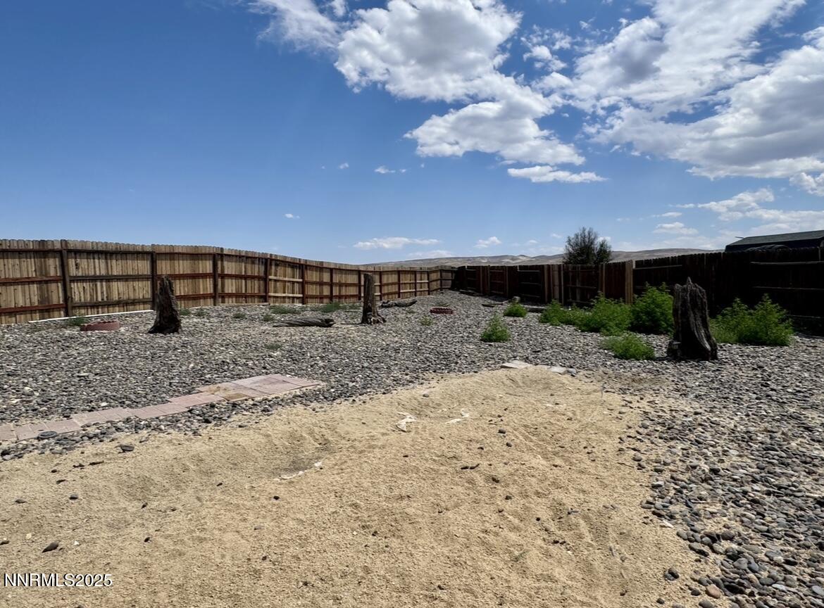 602 Tamsen Road Fernley, NV 89408 - Photo 6 of 18 a view of a dry yard with wooden fence