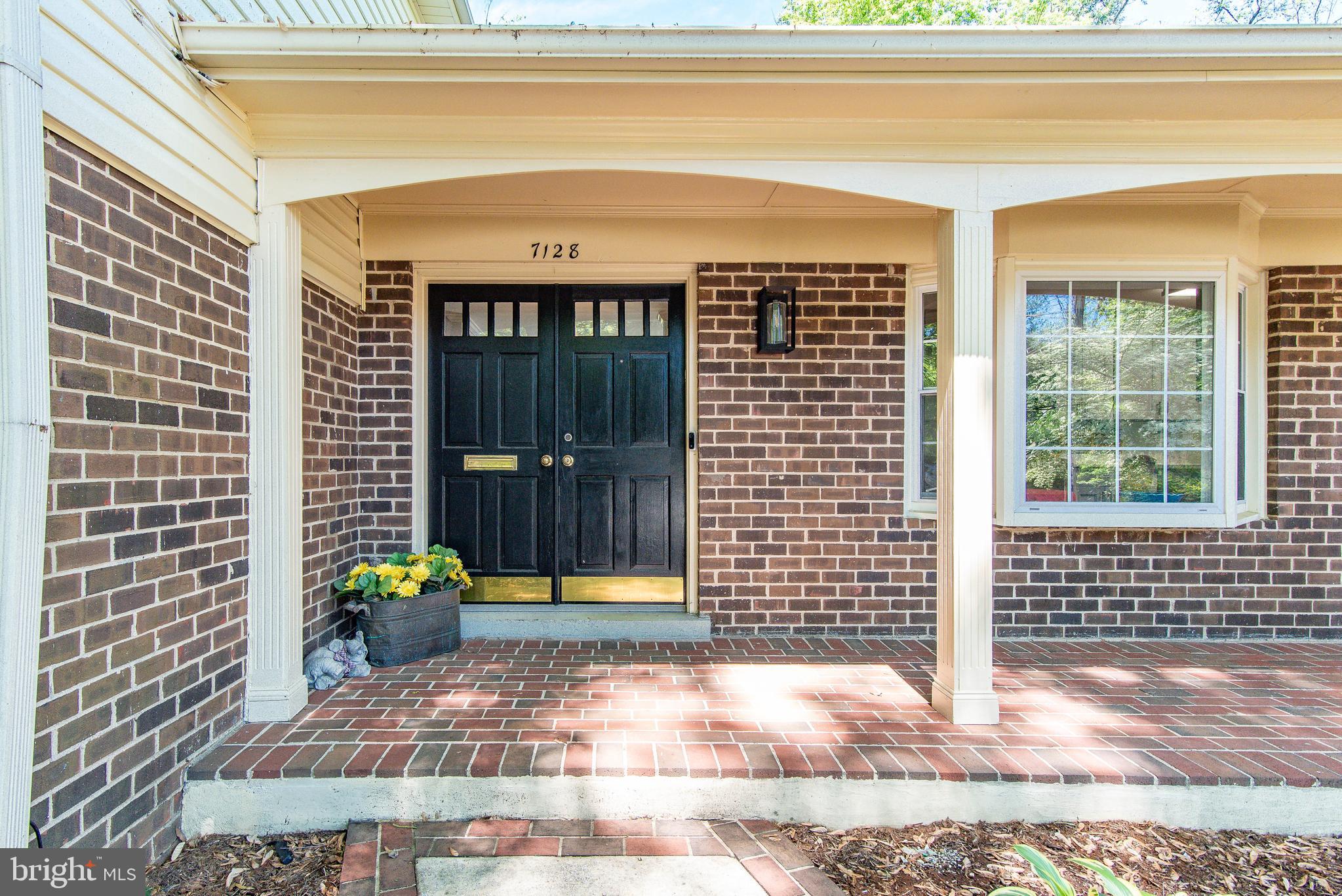 Gracious and practical, double door covered entry