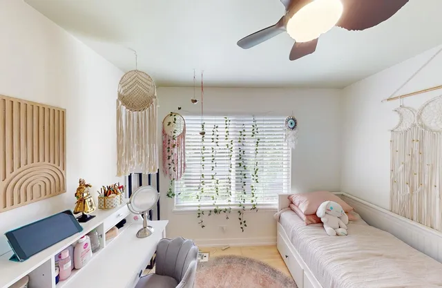 a bedroom with furniture and a large window