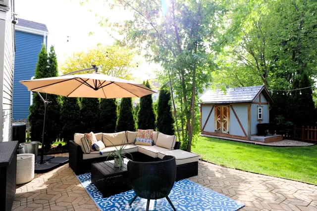 a view of yard with furniture and tub