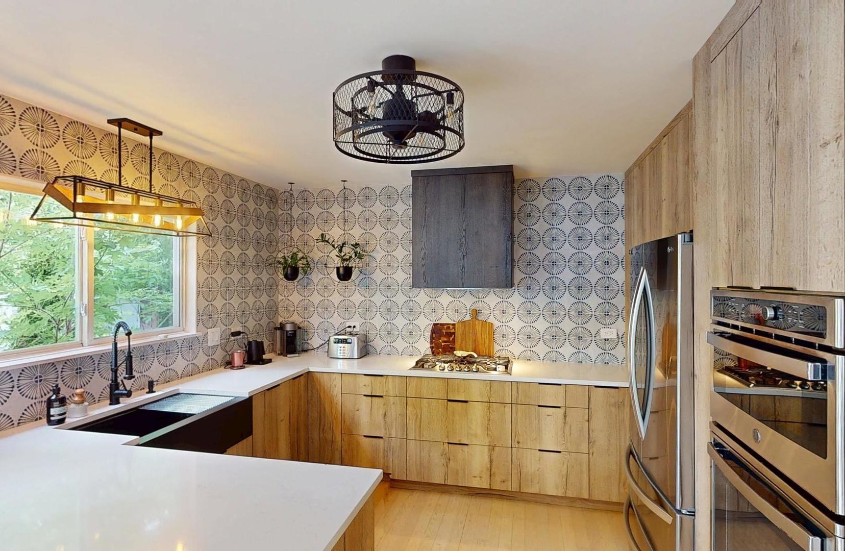2207 Periwinkle Lane Naperville, IL 60540 - Photo 6 of 40 a kitchen with stainless steel appliances a sink a stove and a microwave