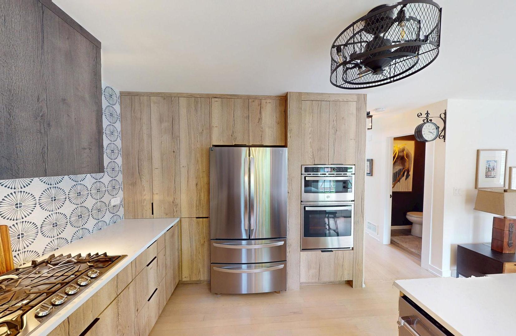 2207 Periwinkle Lane Naperville, IL 60540 - Photo 7 of 40 a kitchen with stainless steel appliances a refrigerator and a stove top oven