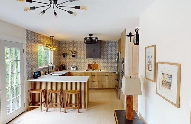 a very nice looking room with kitchen view