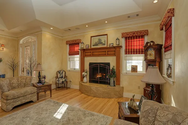 a living room with furniture and a chandelier