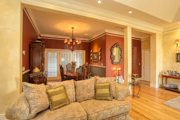 a view of a dining room with furniture and chandelier