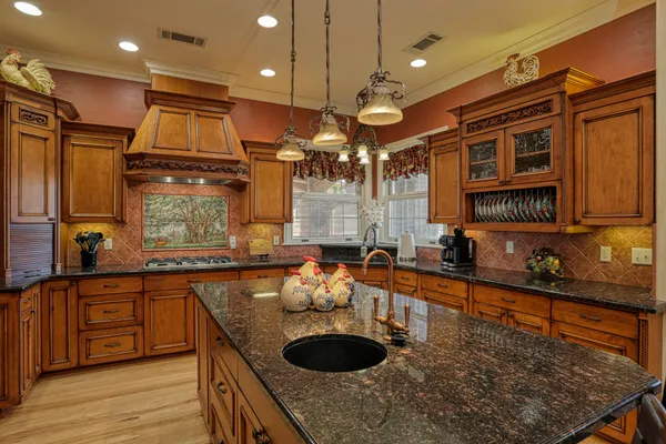 a kitchen with sink a stove and cabinets