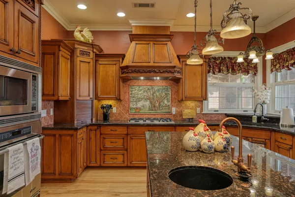 a dining room with wooden floor and chandelier