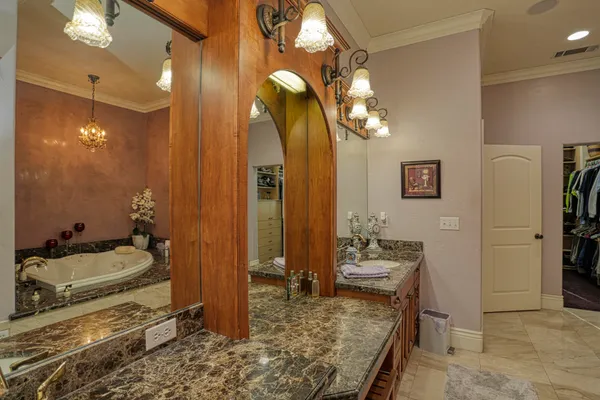 a spacious bathroom with a bathtub and double sink