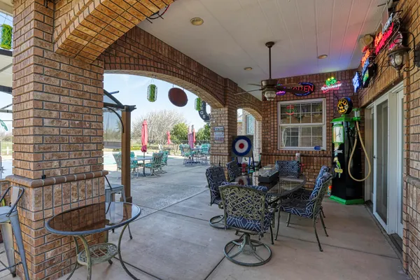 a view of a house with patio and a yard