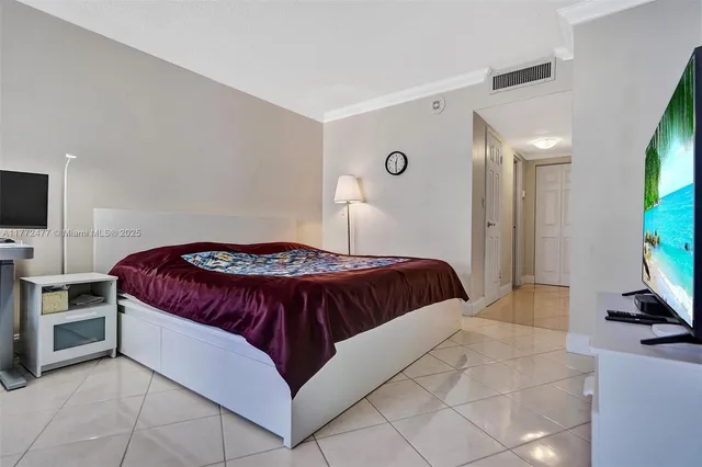 a bedroom with a bed and a television