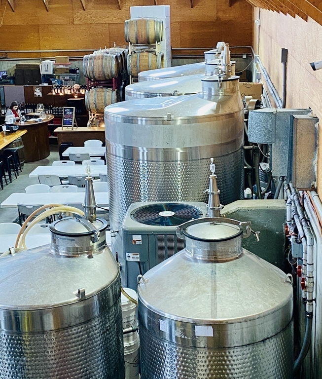 335 Old Fall River Road Dartmouth, MA 02747 - Photo 16 of 32 a view of a patio with table and chairs potted plants