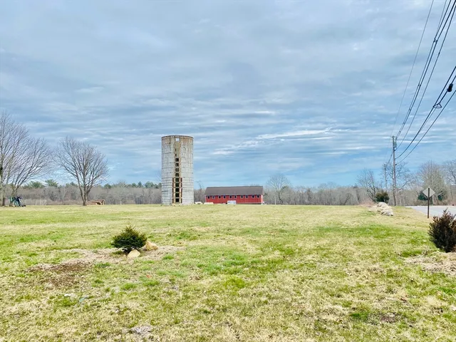 a bed with a small white comforter and pillows