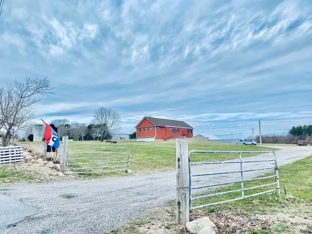 a patio with a table and chairs and potted plants