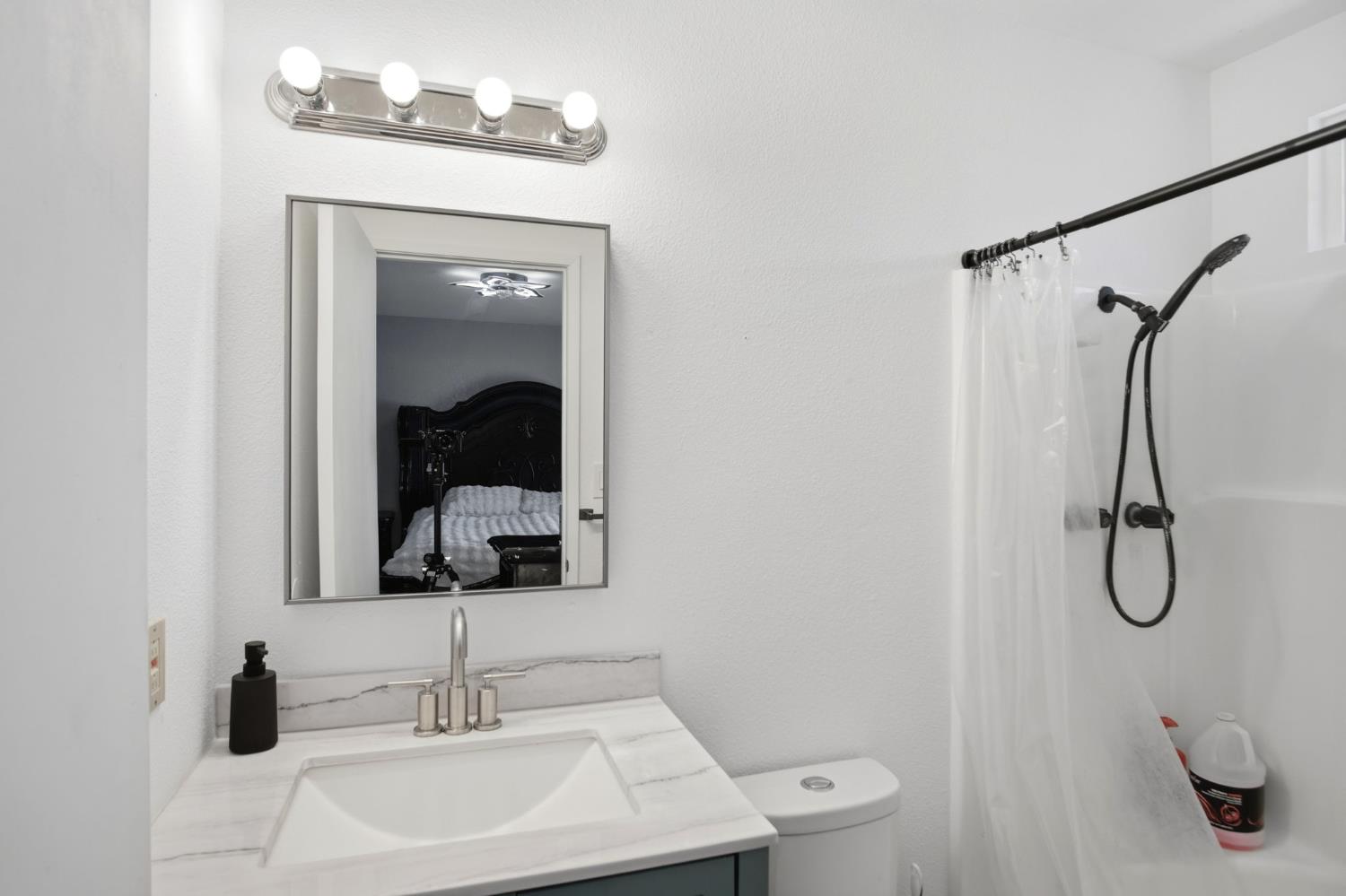 1308 Basil Court Newman, CA 95360 - Photo 16 of 20 a bathroom with a sink a light fixture and a mirror