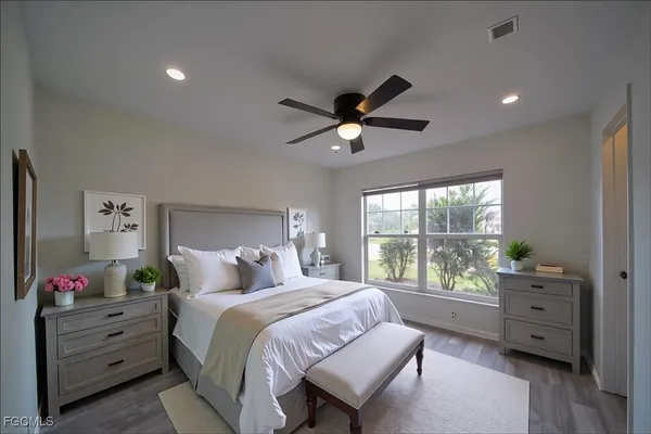 a bedroom with a bed and a large window