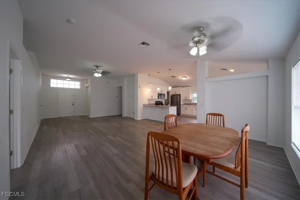a dining room with furniture and wooden floor