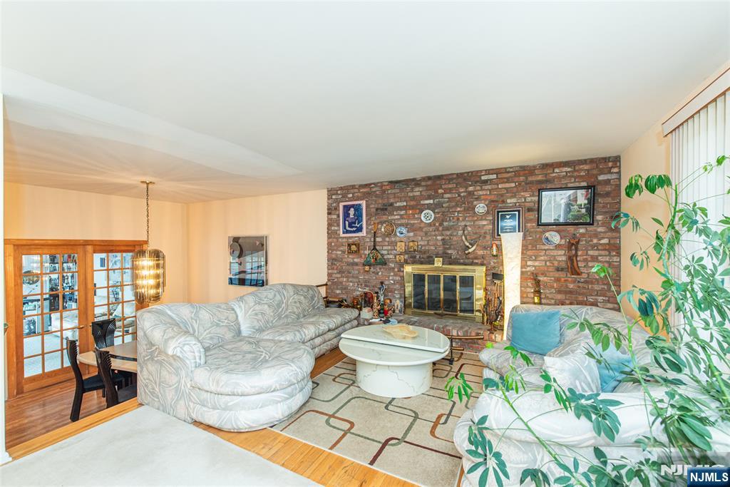 12 Abbott Road Wayne, NJ 07470 - Photo 5 of 49 a living room with fireplace furniture and a potted plant