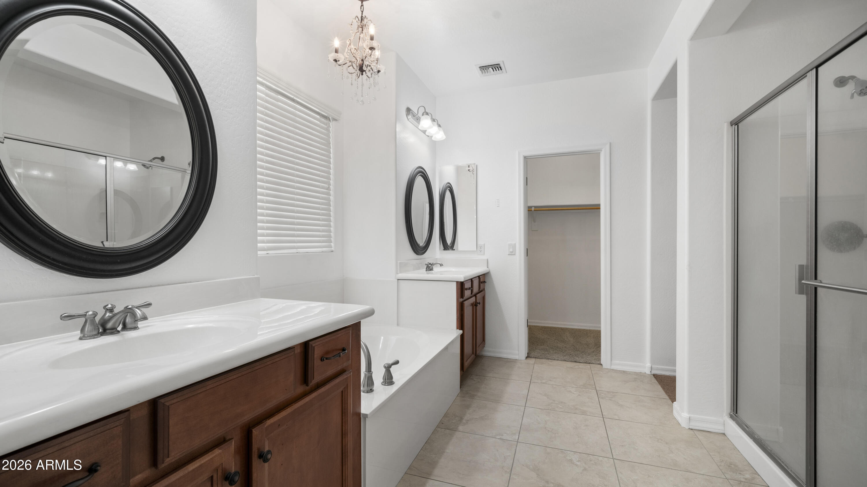 16159 West Granada Road Goodyear, AZ 85395 - Photo 27 of 41 a spacious bathroom with a double vanity sink and a mirror