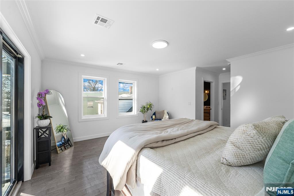 784 Valley Street Union, NJ 07088 - Photo 21 of 49 a bedroom with a bed a window and a flat screen television