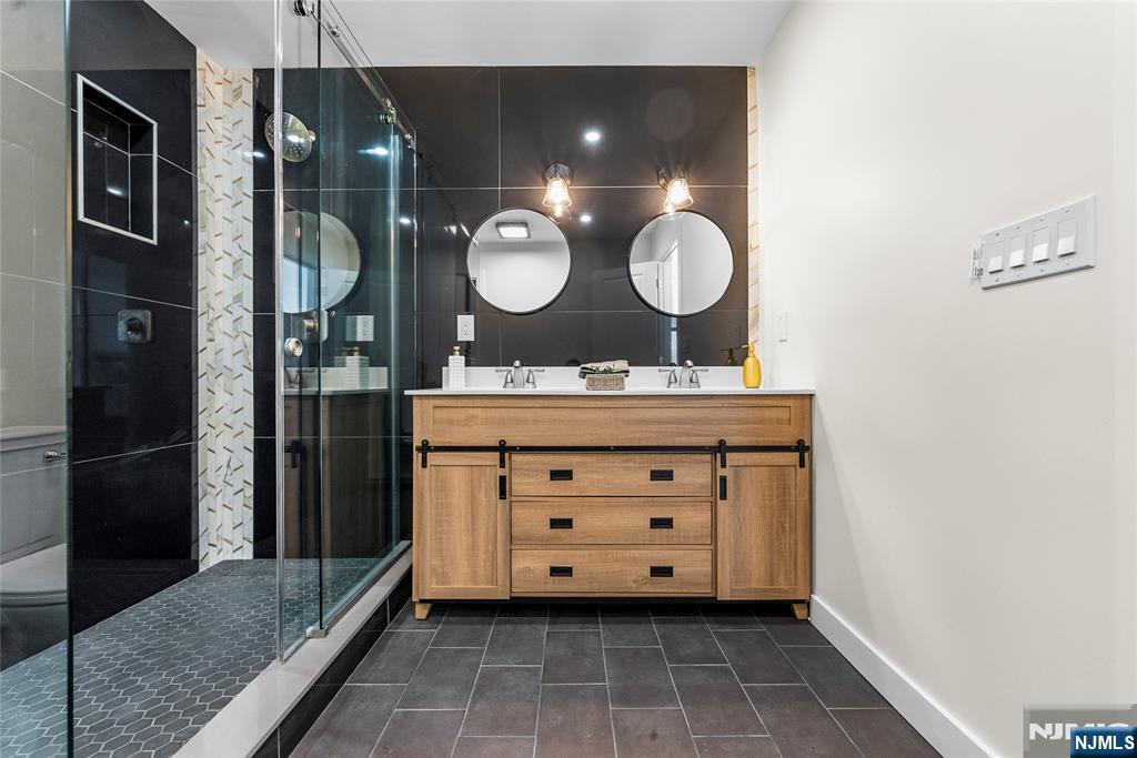 784 Valley Street Union, NJ 07088 - Photo 22 of 49 a bathroom with a sink mirror and cabinets