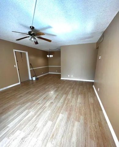an empty room with wooden floor and closet