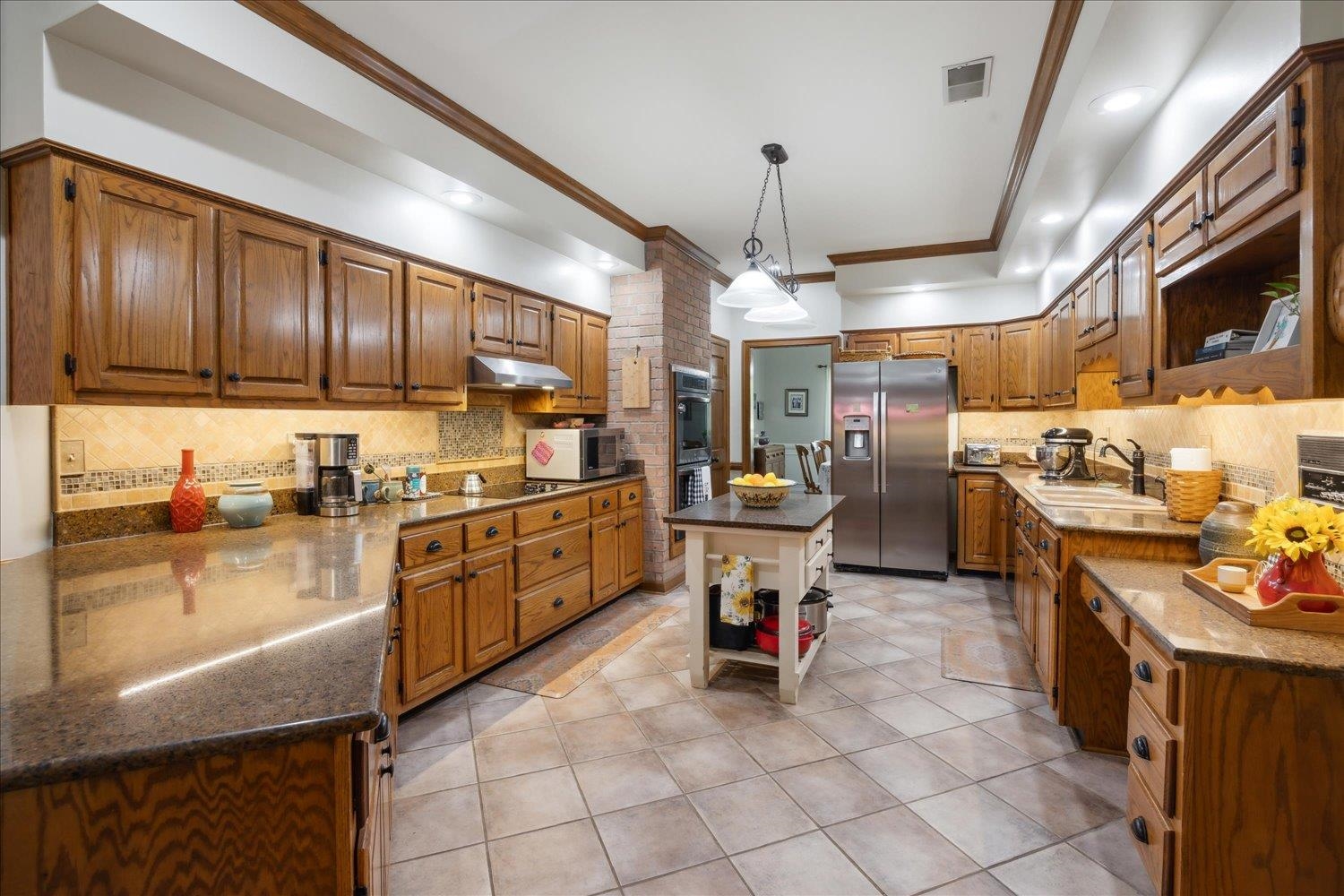 7051 7th Road Bartlett, TN 38135 - Photo 11 of 37 Warm, classic kitchen with brick accents and ample storage. Appliances are less than 3 years old!