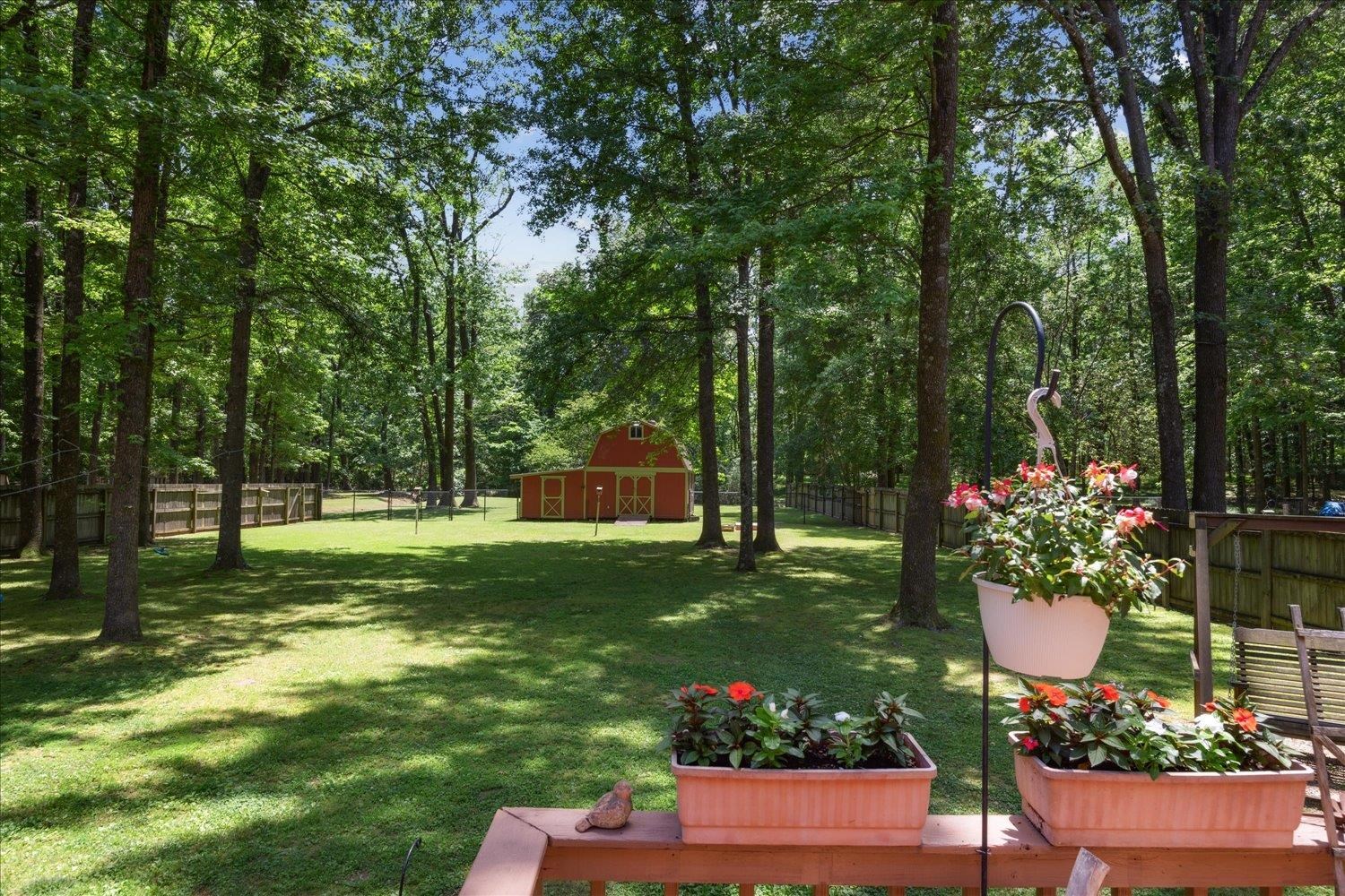 7051 7th Road Bartlett, TN 38135 - Photo 34 of 37 Shady, fenced level yard with large deck, perfect for entertaining! Note-lot extends past fence towards street.