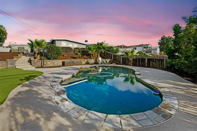 a view of a swimming pool with an outdoor space and seating area
