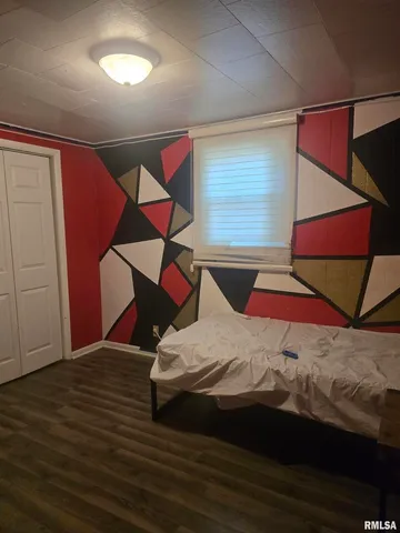 a bed sitting in a bedroom next to a window