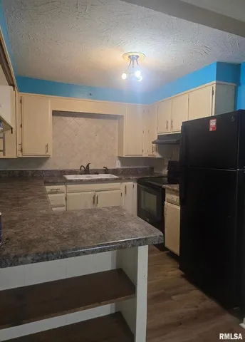 a kitchen with kitchen island a counter top space a sink and appliances