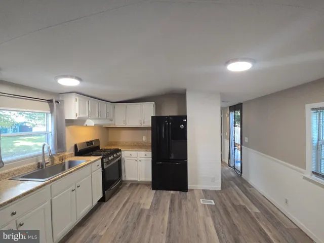 a kitchen with a refrigerator and a sink