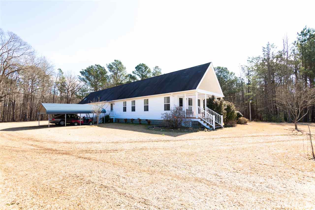 333 West Watson Road Benson, NC 27504 - Photo 1 of 25 a front view of a house with a yard covered in snow