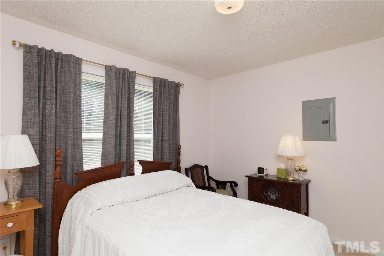 333 West Watson Road Benson, NC 27504 - Photo 12 of 25 a bedroom with a bed and a lamp