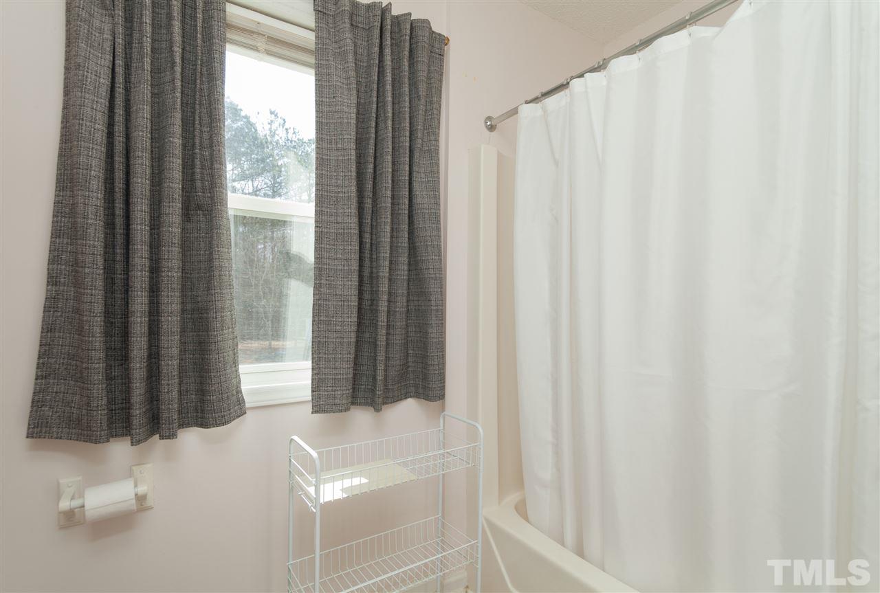 333 West Watson Road Benson, NC 27504 - Photo 16 of 25 a bathroom with a shower curtain