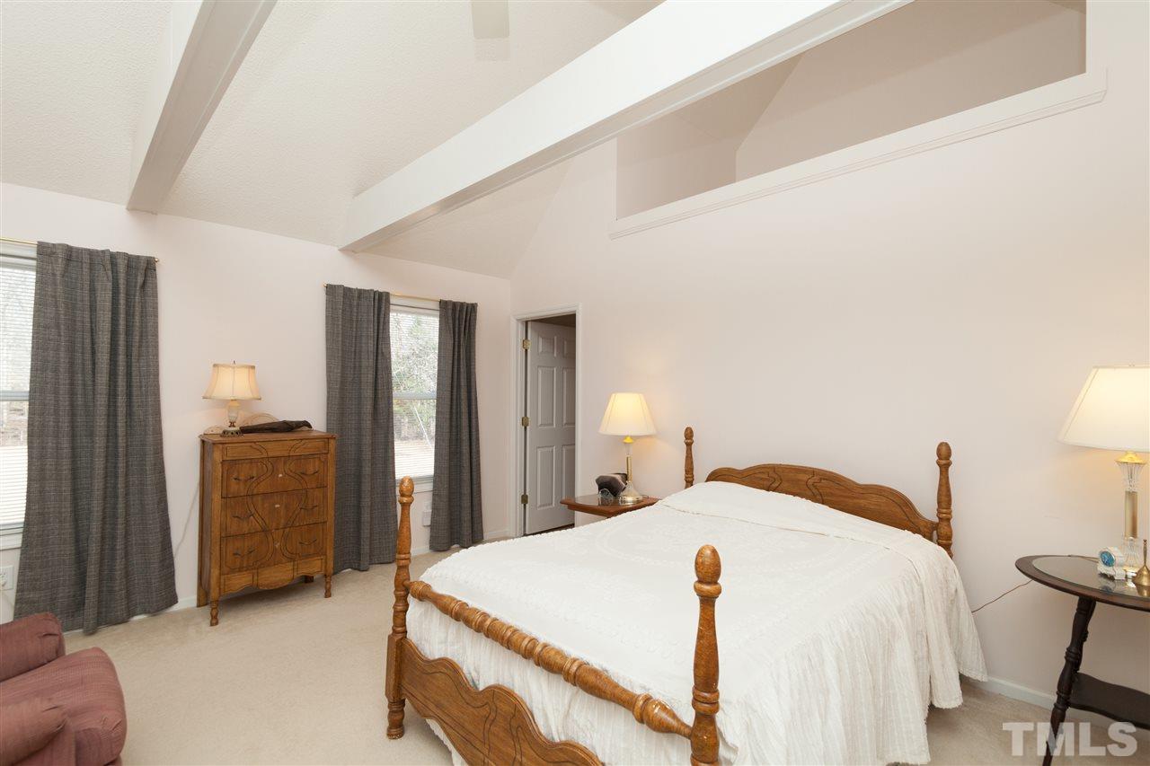 333 West Watson Road Benson, NC 27504 - Photo 19 of 25 a spacious bedroom with a bed and a lamp