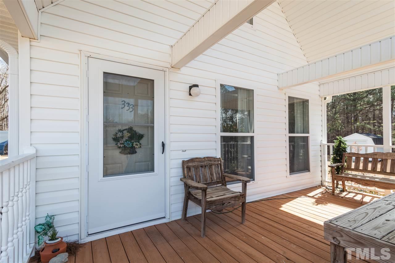 333 West Watson Road Benson, NC 27504 - Photo 5 of 25 a balcony with furniture and wooden floor