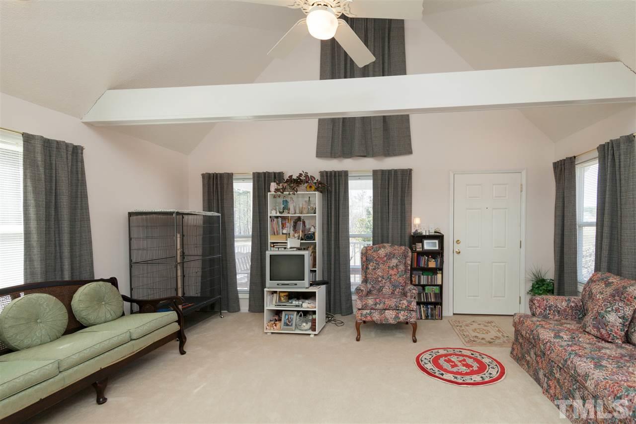 333 West Watson Road Benson, NC 27504 - Photo 7 of 25 a living room with furniture and a chandelier