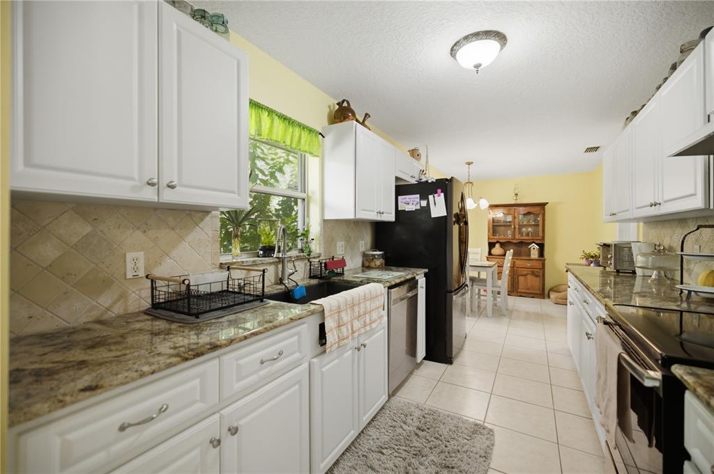 17900 Northwest 120th Avenue Road Reddick, FL 32686 - Photo 39 of 45 a kitchen with counter top space cabinets and stainless steel appliances