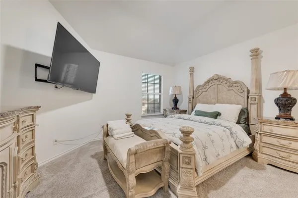 a bedroom with a bed and flat screen tv