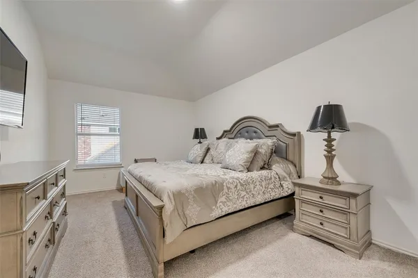 a bedroom with a bed and window