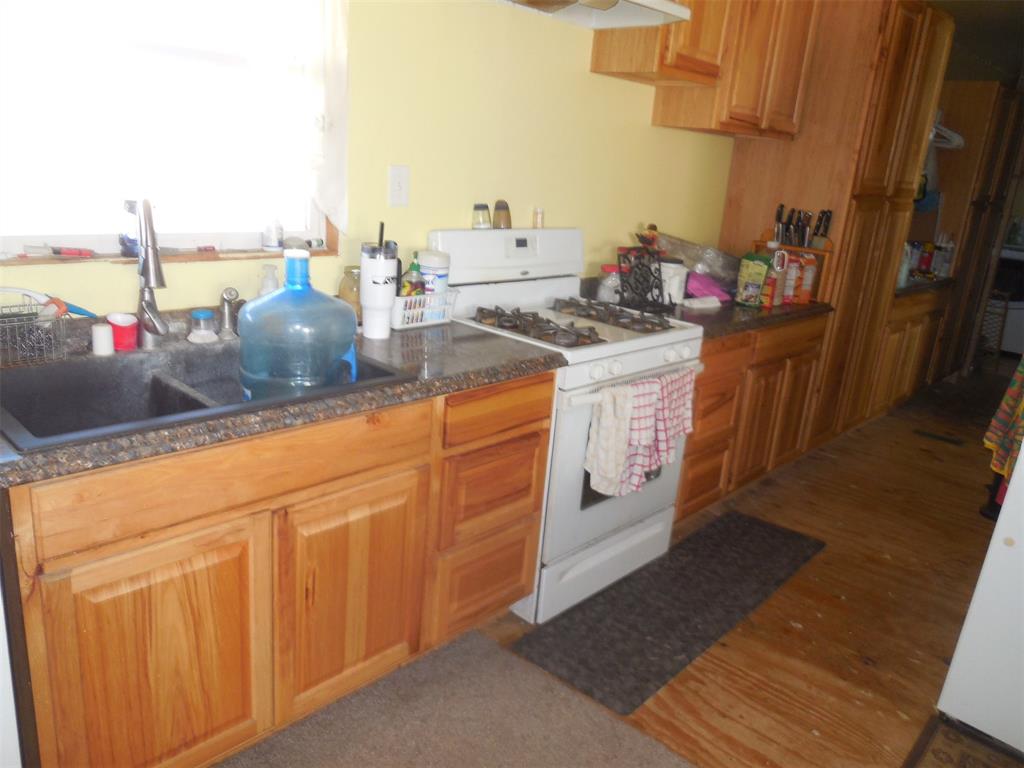 12436 County Road 134 Ranger, TX 76470 - Photo 15 of 32 a kitchen with stainless steel appliances granite countertop a sink stove and cabinets