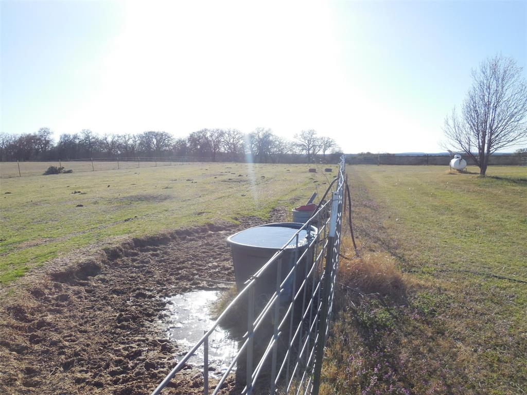 12436 County Road 134 Ranger, TX 76470 - Photo 7 of 32 a view of a lake with a yard and large trees