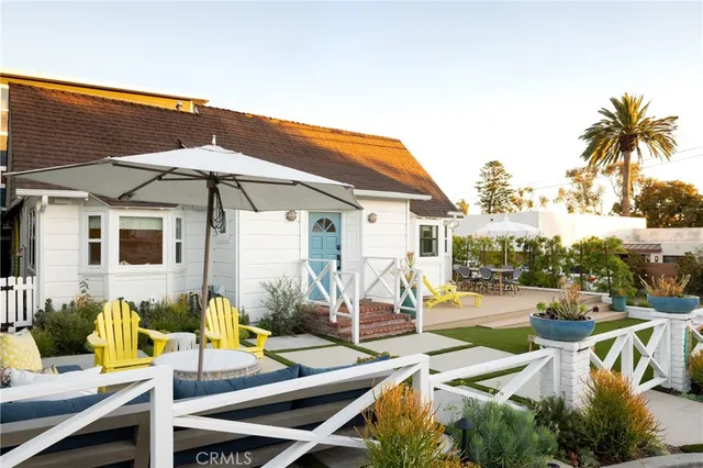 a view of a patio with chairs and umbrellas on the terrace