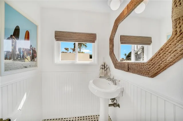 a bathroom with a sink a mirror and a window