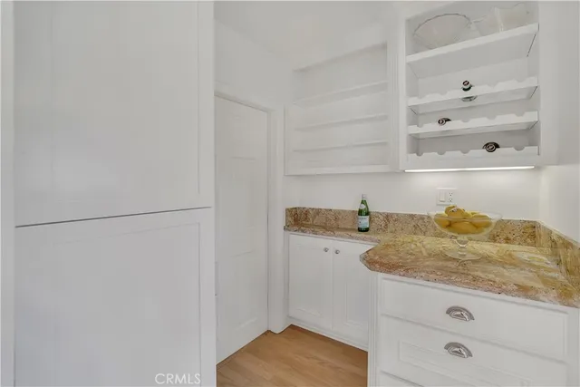 a bathroom with a granite countertop and white sink