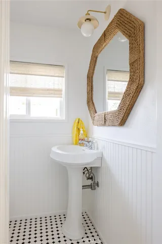 a bathroom with a sink a toilet and a window
